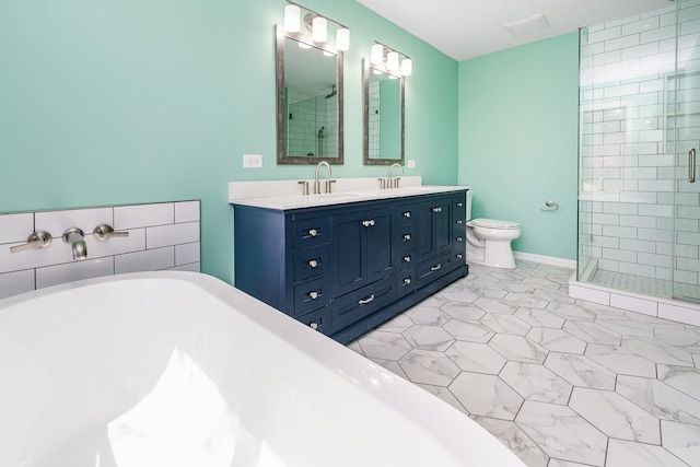 full bath featuring a shower stall, a soaking tub, double vanity, and toilet