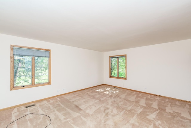 spare room with baseboards and carpet