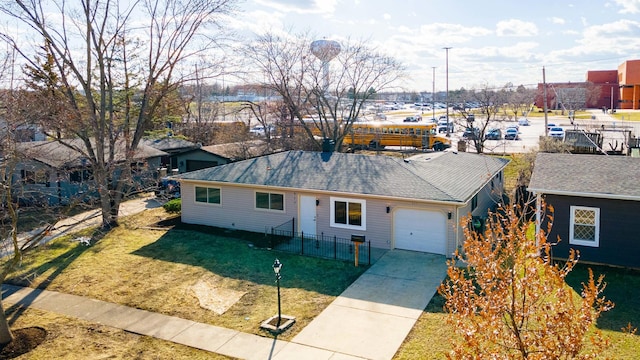 single story home with concrete driveway, fence, a front lawn, and a garage
