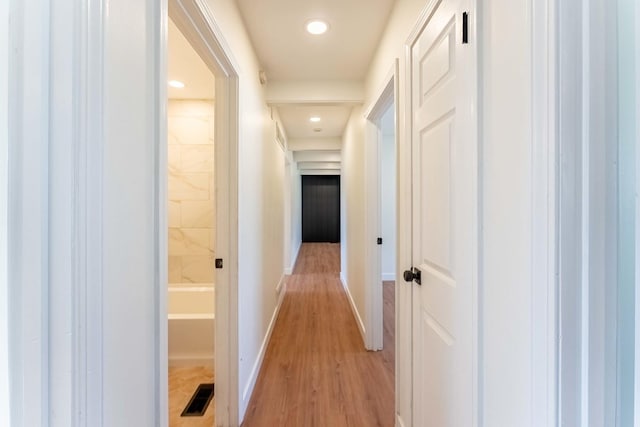 hallway featuring recessed lighting, baseboards, visible vents, and light wood-type flooring