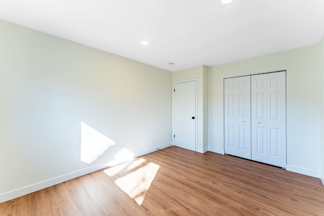 unfurnished bedroom featuring recessed lighting, baseboards, and light wood-style floors