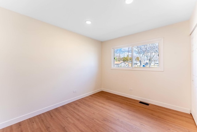 spare room with recessed lighting, baseboards, visible vents, and light wood-style floors