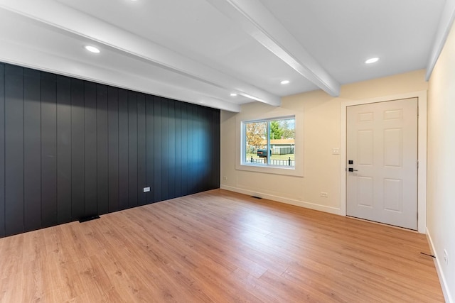 empty room featuring recessed lighting, beam ceiling, and light wood finished floors