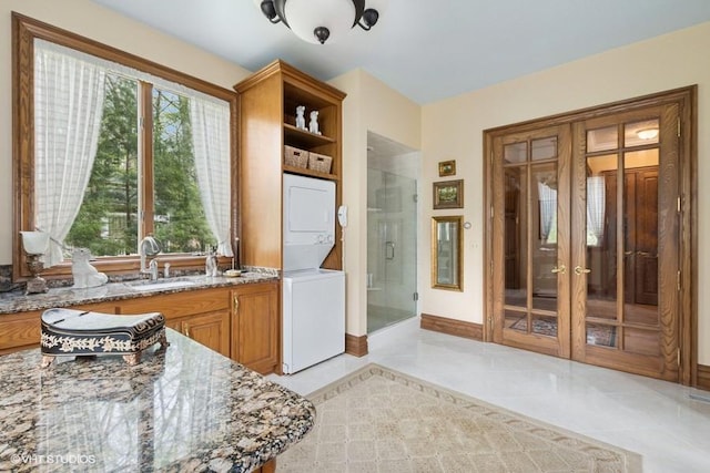 821 Chatfield Rd, New Lenox, IL 60451 - kitchen featuring stacked washer / drying machine, a sink, plenty of natural light, and light stone counters