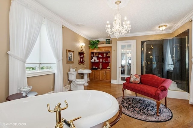821 Chatfield Rd, New Lenox, IL 60451 - living area featuring healthy amount of natural light, wood finished floors, crown molding, a chandelier, and baseboards