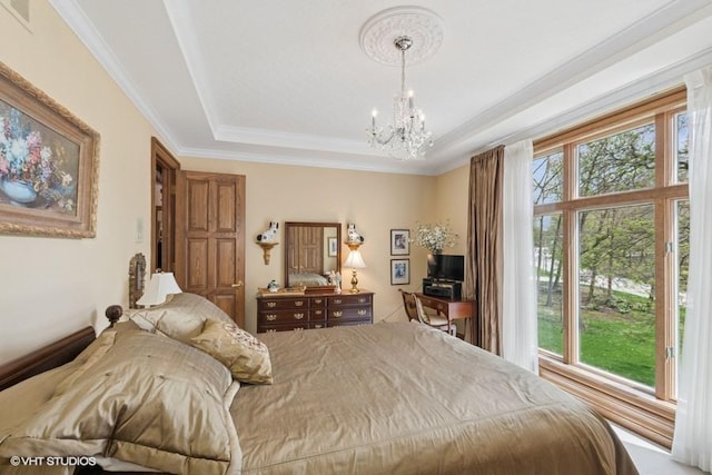 bedroom featuring an inviting chandelier, ornamental molding, a tray ceiling, and visible vents