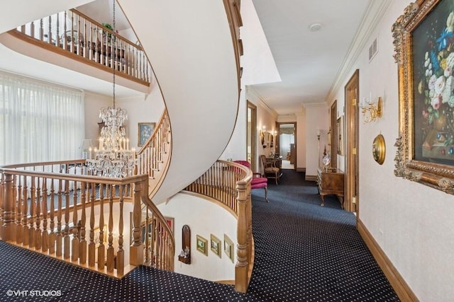 hallway with a notable chandelier, carpet floors, baseboards, visible vents, and ornamental molding