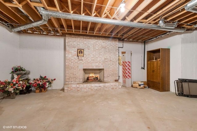 unfinished basement featuring a brick fireplace