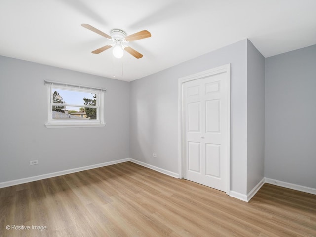 767 May St, Calumet City, IL 60409 - unfurnished bedroom with light wood-style floors, baseboards, and a ceiling fan