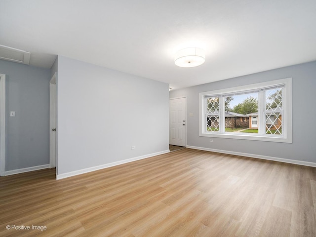 767 May St, Calumet City, IL 60409 - empty room featuring light wood finished floors, baseboards, and attic access