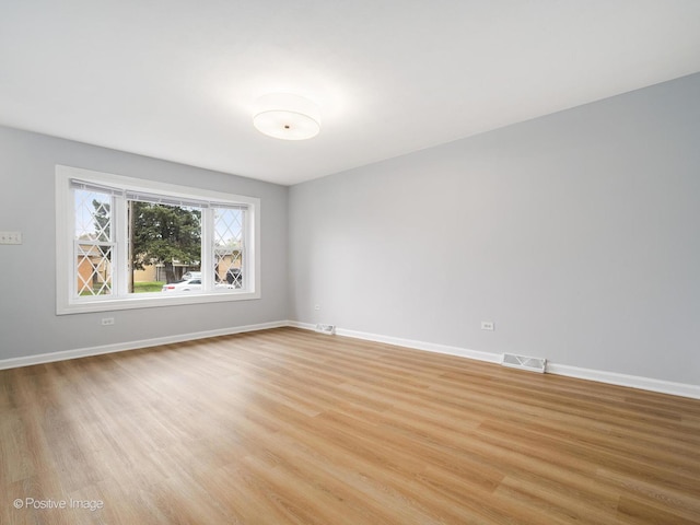 767 May St, Calumet City, IL 60409 - empty room with light wood-style floors and baseboards