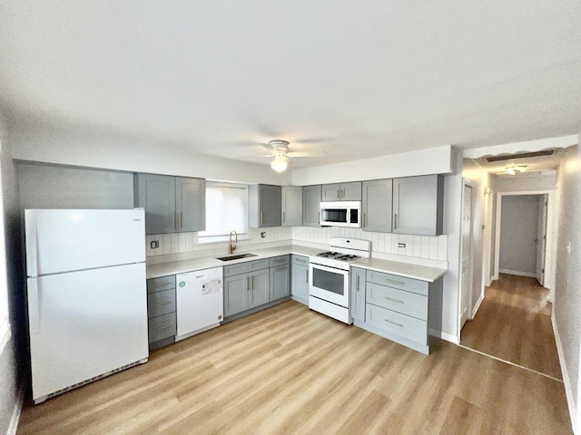 767 May St, Calumet City, IL 60409 - kitchen with white appliances, a sink, gray cabinets, light wood-style floors, and decorative backsplash