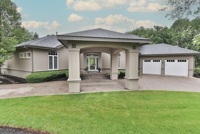 67 Katrina Ln, Sleepy Hollow, IL 60118 - rear view of property with a lawn, roof with shingles, stucco siding, and driveway