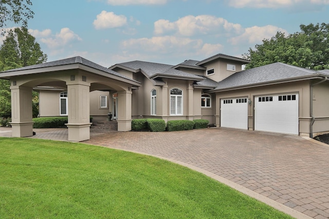 67 Katrina Ln, Sleepy Hollow, IL 60118 - prairie-style house featuring stucco siding, a front lawn, an attached garage, and decorative driveway
