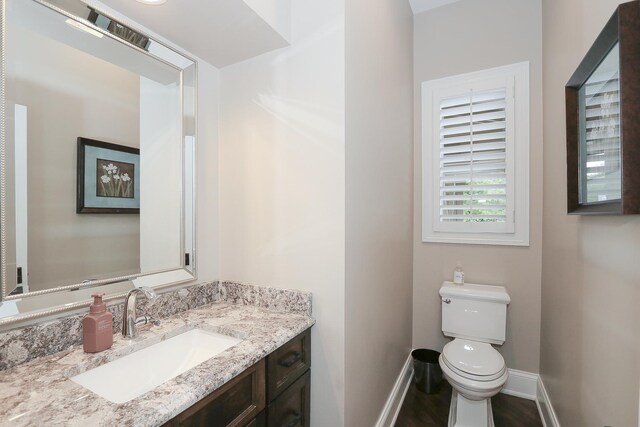 67 Katrina Ln, Sleepy Hollow, IL 60118 - half bath featuring baseboards, toilet, vanity, and wood finished floors
