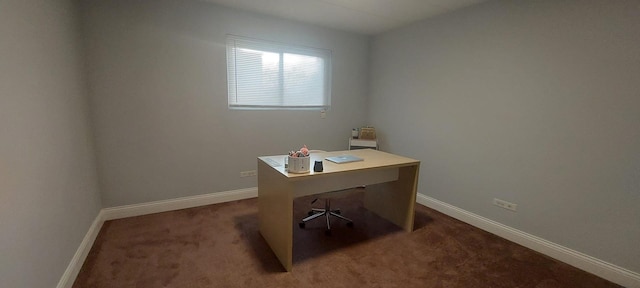 office space with baseboards and dark carpet