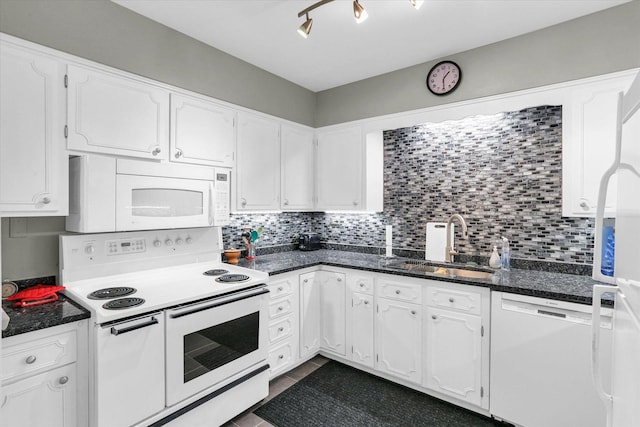 kitchen with white appliances, a sink, white cabinets, and tasteful backsplash