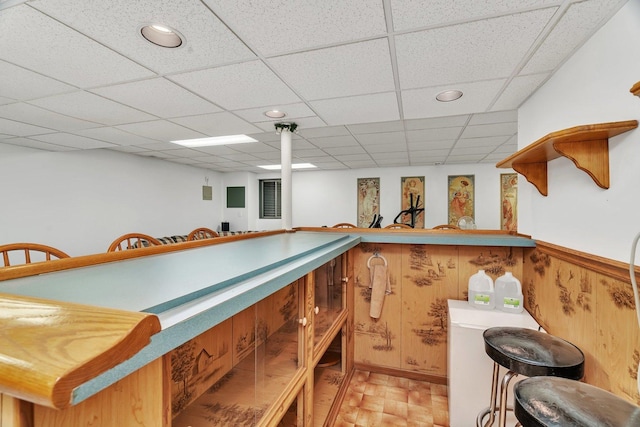 interior space featuring recessed lighting, wood walls, bar area, and a paneled ceiling