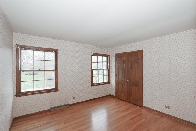 202 Heath Ct, Barrington, IL 60010 - empty room featuring wallpapered walls, visible vents, baseboards, and light wood-type flooring