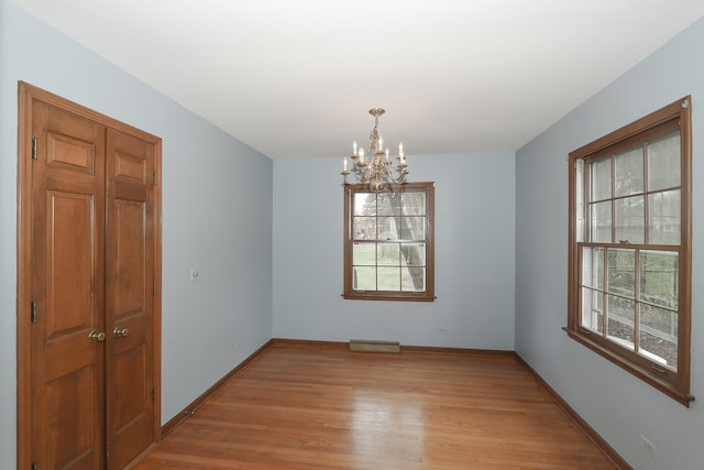 202 Heath Ct, Barrington, IL 60010 - empty room with baseboards, a notable chandelier, visible vents, and light wood-type flooring