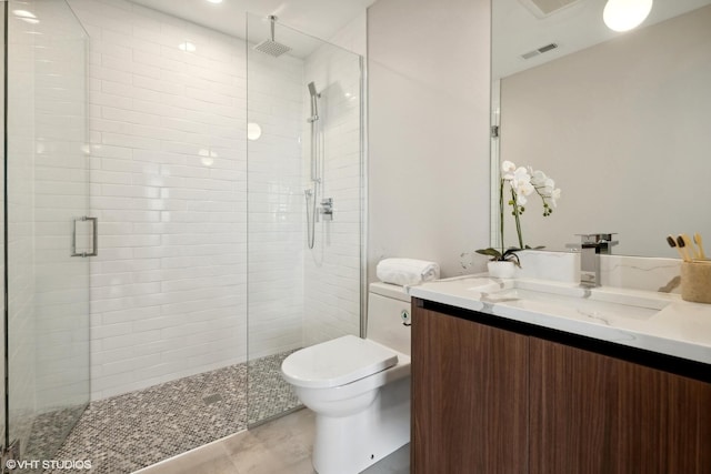 full bathroom with visible vents, a shower stall, vanity, tile patterned floors, and toilet