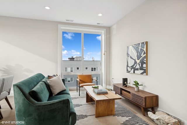 living room featuring recessed lighting and visible vents