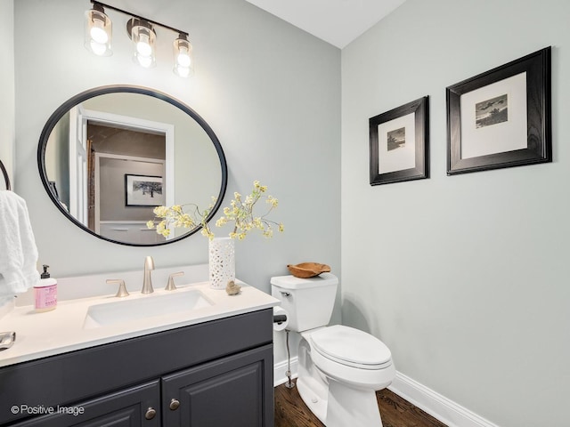 1301 Hawkins Ct, Saint Charles, IL 60174 - bathroom featuring toilet, baseboards, wood finished floors, and vanity