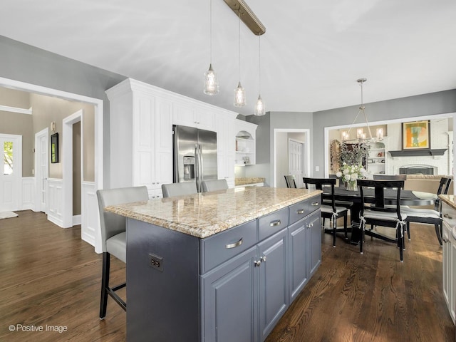 1301 Hawkins Ct, Saint Charles, IL 60174 - kitchen with stainless steel fridge, white cabinetry, dark wood finished floors, a kitchen island, and light stone counters