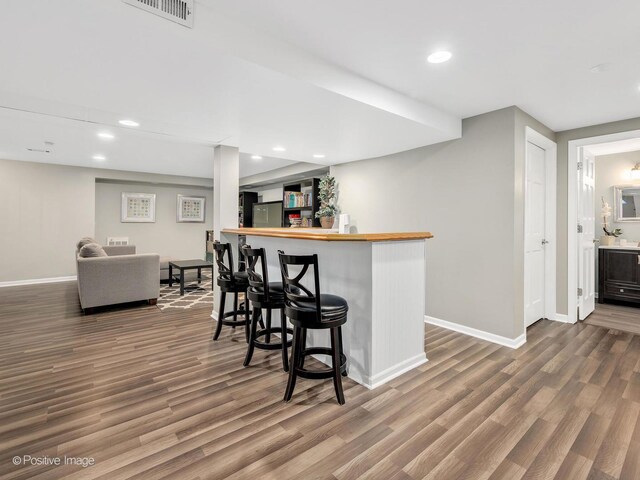 1301 Hawkins Ct, Saint Charles, IL 60174 - bar with a bar, wood finished floors, visible vents, and baseboards