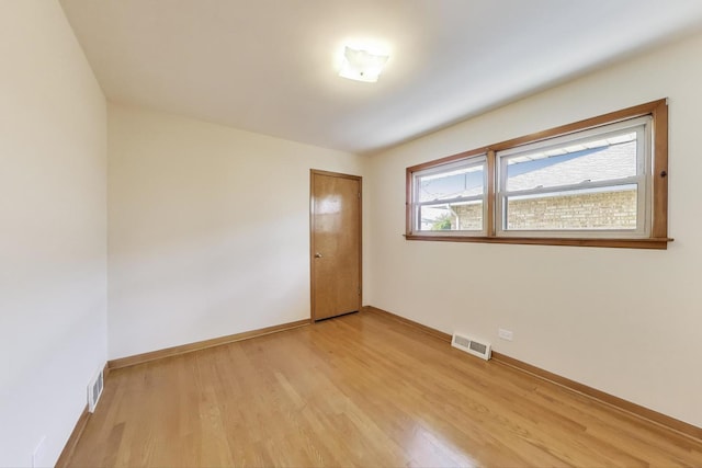 empty room with light wood-style floors and baseboards