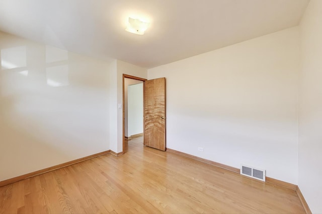 empty room with light wood-style flooring and baseboards