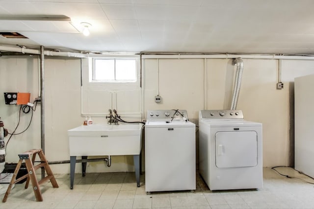 clothes washing area with washing machine and clothes dryer