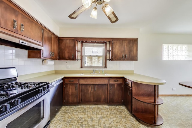kitchen with stainless steel appliances, a sink, a peninsula, under cabinet range hood, and light floors