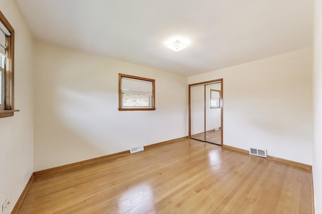 spare room featuring light wood-style flooring and baseboards