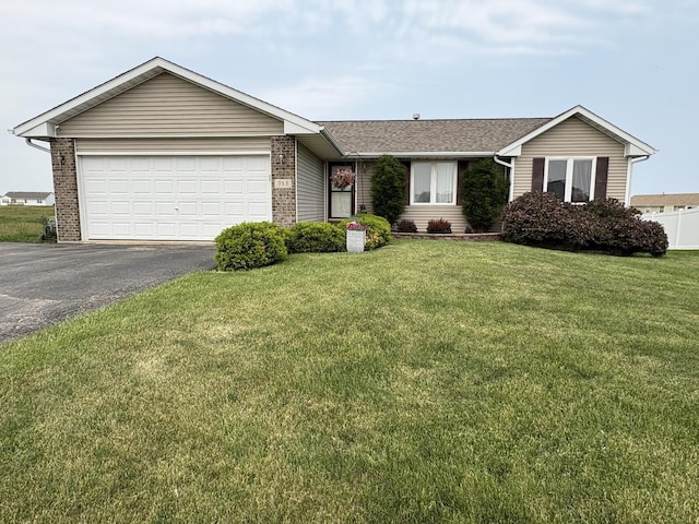 753 Golden Prairie Dr, Davis Junction, IL 61020 - single story home with asphalt driveway, a front yard, an attached garage, brick siding, and roof with shingles