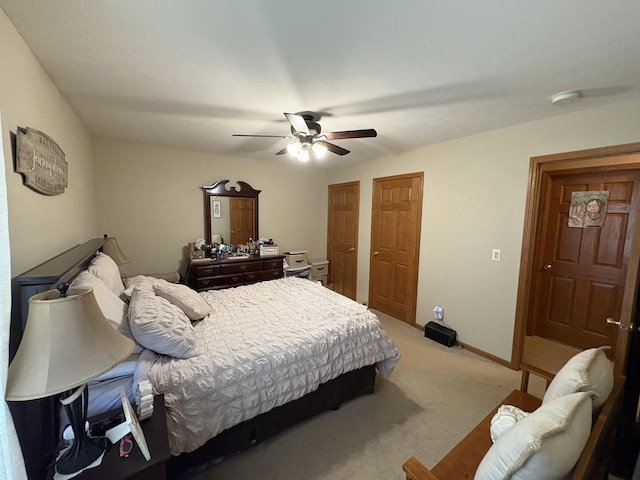 753 Golden Prairie Dr, Davis Junction, IL 61020 - bedroom featuring light colored carpet, a ceiling fan, and two closets