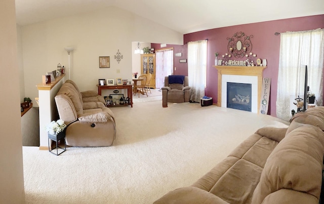 753 Golden Prairie Dr, Davis Junction, IL 61020 - carpeted living room featuring a tiled fireplace, lofted ceiling, and plenty of natural light