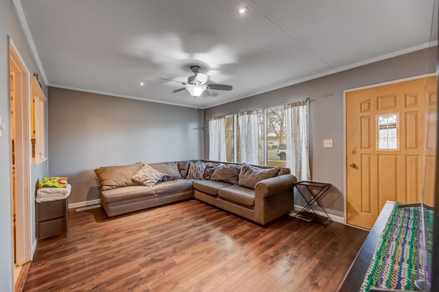 living area with baseboards, ornamental molding, dark wood-style flooring, and ceiling fan