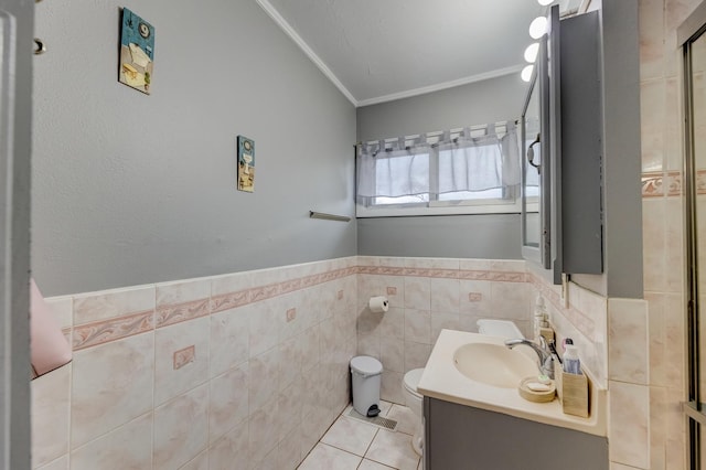bathroom featuring crown molding, vanity, toilet, tile patterned floors, and tile walls