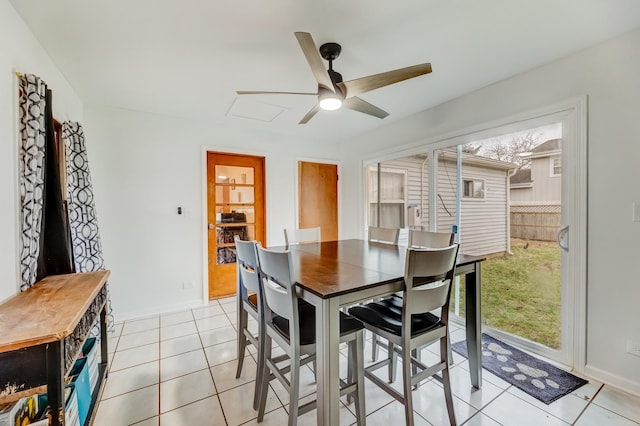 dining area with baseboards, a ceiling fan, and light tile patterned flooring