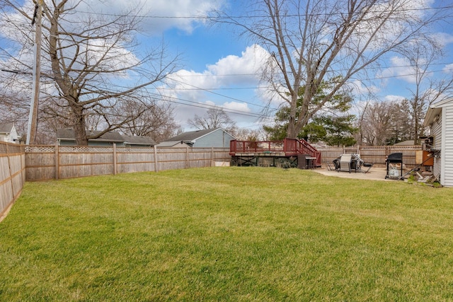 view of yard with a patio, a fenced backyard, and a deck