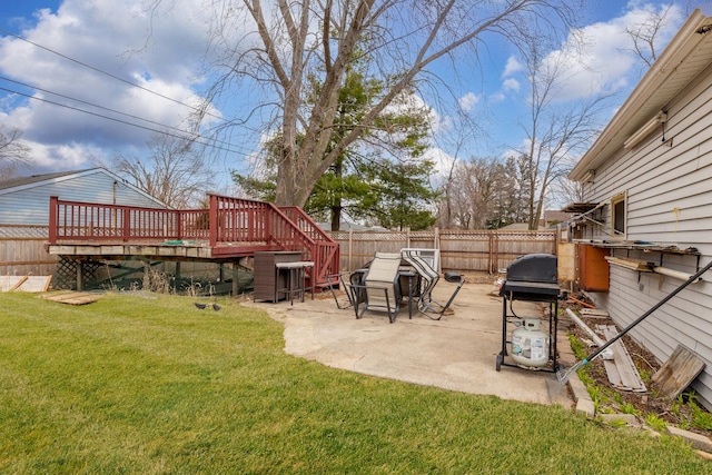 view of yard with a wooden deck, a fenced backyard, and a patio area