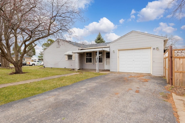 single story home featuring driveway, a front yard, fence, an attached garage, and a shingled roof