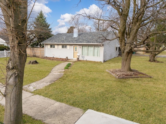 view of front of property with fence, a chimney, a shingled roof, and a front lawn