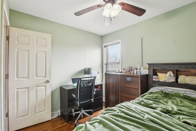 bedroom featuring baseboards, dark wood-style floors, and ceiling fan