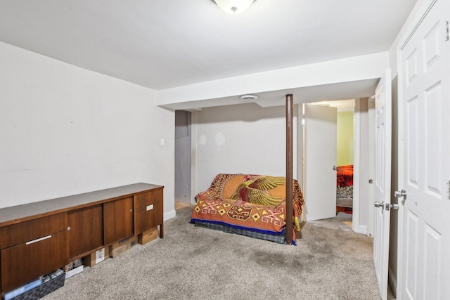 living area featuring baseboards and light colored carpet