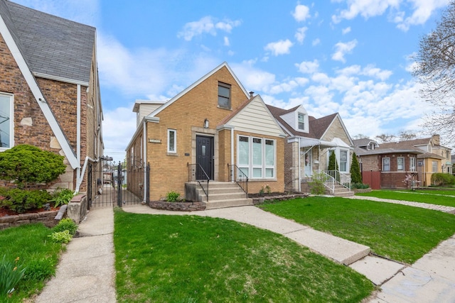 bungalow-style house with a gate, a front yard, and brick siding