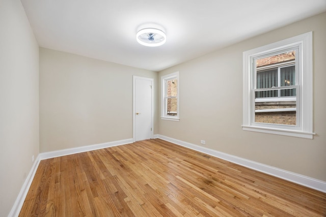 spare room with visible vents, baseboards, and light wood-type flooring