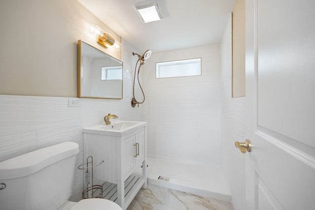 full bath with toilet, a tile shower, marble finish floor, and vanity