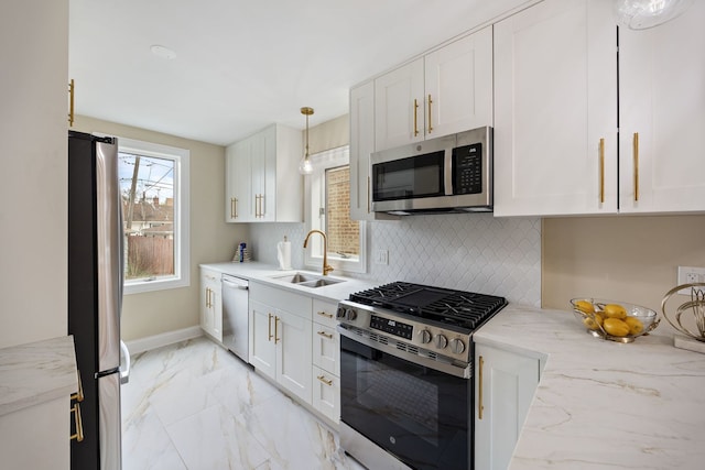 kitchen featuring decorative backsplash, marble finish floor, white cabinets, a sink, and appliances with stainless steel finishes